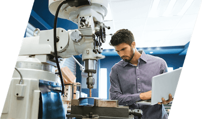 An employee adjusting a machine.